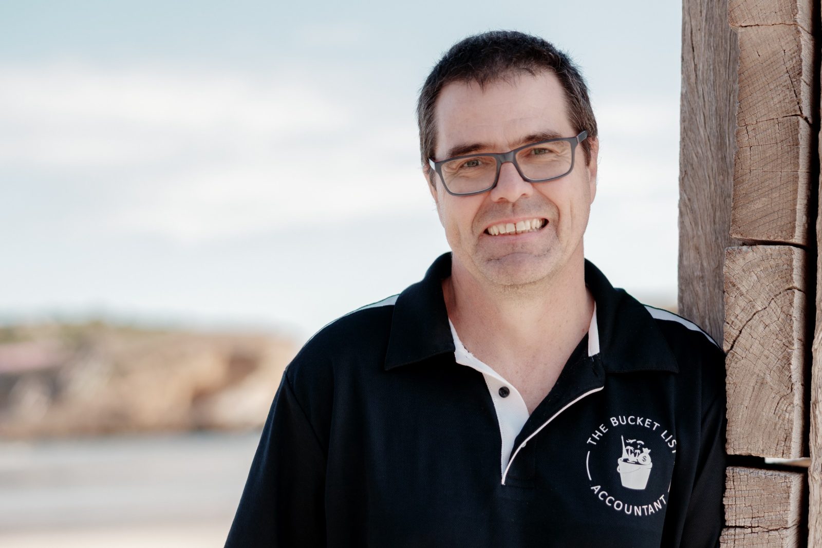 David Patterson smiling by the beach